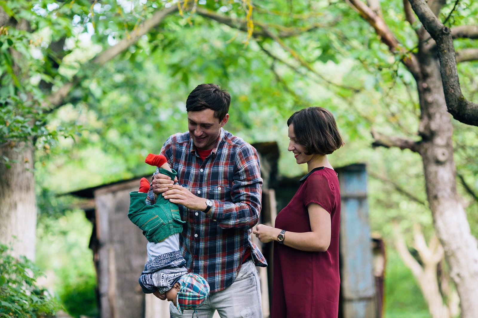 happy-mother-watching-man-playing-with-baby